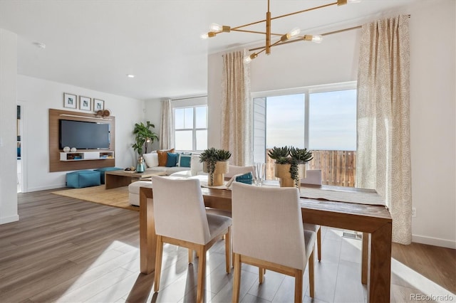 dining area featuring an inviting chandelier and hardwood / wood-style floors