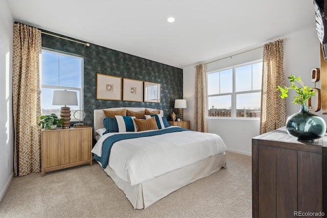 bedroom featuring multiple windows and light carpet