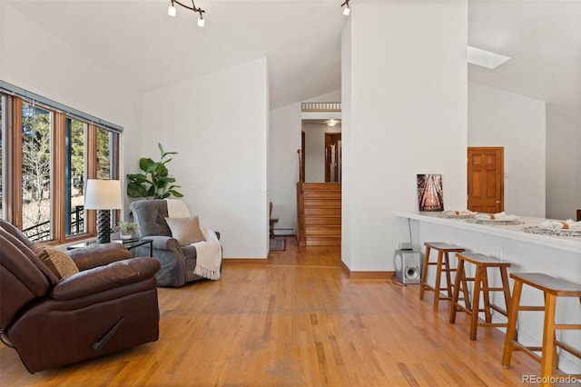 sitting room featuring light wood-type flooring and lofted ceiling