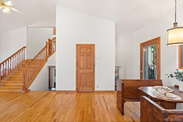 interior space with light hardwood / wood-style floors and high vaulted ceiling