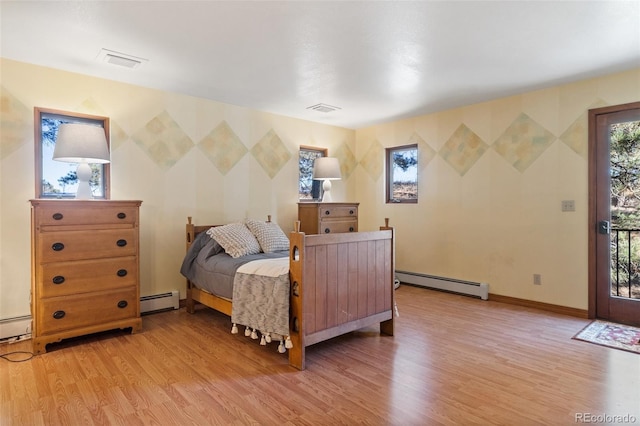 bedroom featuring a baseboard radiator and light hardwood / wood-style floors