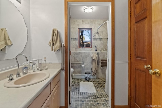 bathroom with a baseboard radiator, tile patterned floors, tiled shower, toilet, and vanity