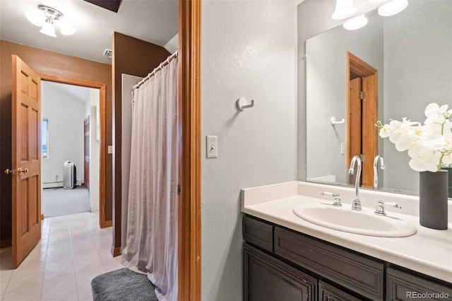 bathroom with tile patterned flooring, vanity, and a baseboard radiator