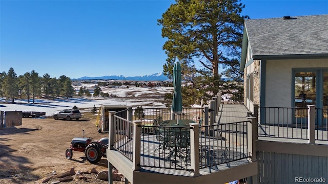 snow covered deck featuring a mountain view