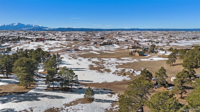 snowy aerial view featuring a mountain view