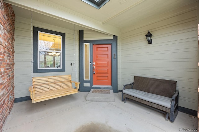 view of exterior entry with a porch