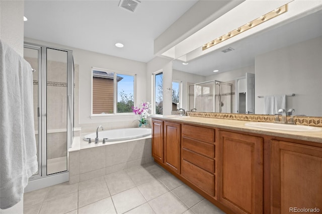 bathroom featuring a stall shower, visible vents, a sink, tile patterned floors, and double vanity