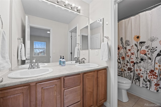 full bath with tile patterned floors, toilet, and a sink