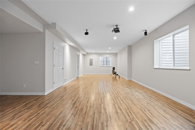 unfurnished living room featuring baseboards, a wealth of natural light, recessed lighting, and light wood-type flooring