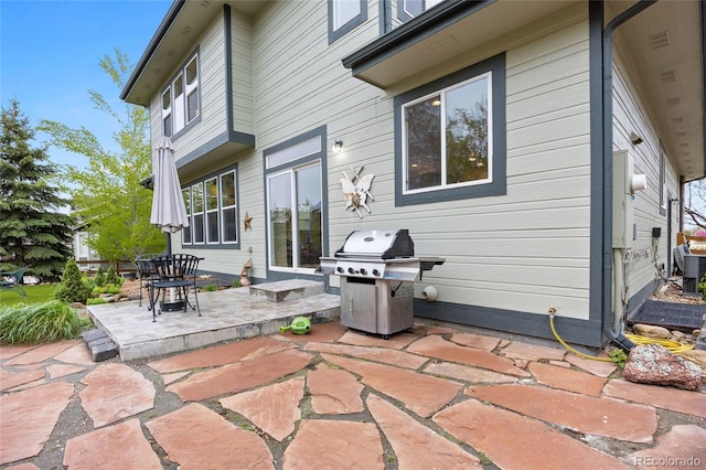 back of property with central AC and a patio area