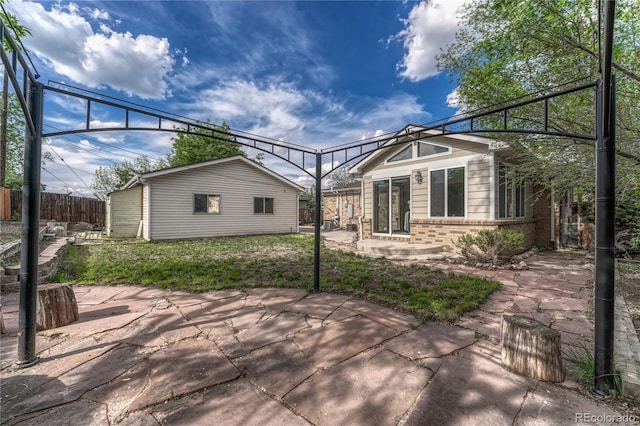 view of patio with fence and an outdoor structure