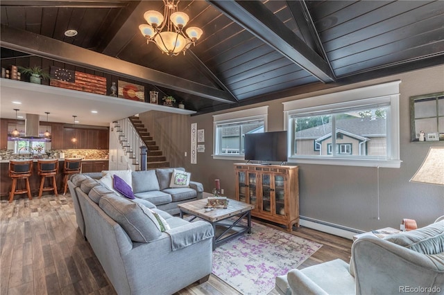 10640 W 46th Ave, Wheat Ridge, CO 80033 - living area featuring a baseboard heating unit, wooden ceiling, wood finished floors, stairs, and a chandelier