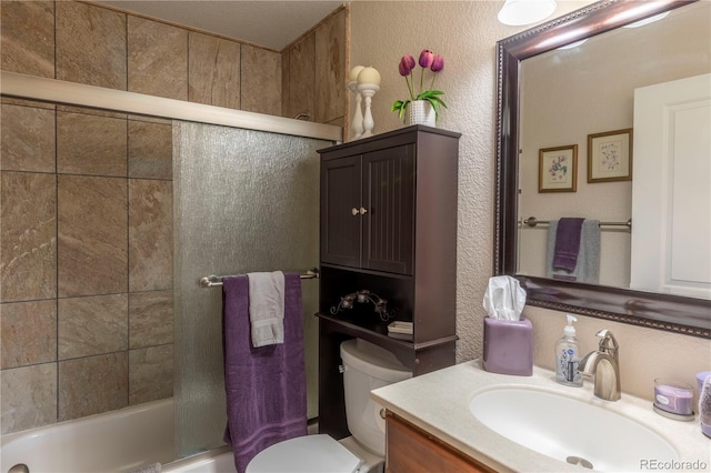 10640 W 46th Ave, Wheat Ridge, CO 80033 - full bathroom featuring toilet, vanity, combined bath / shower with glass door, and a textured wall
