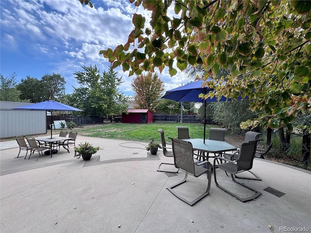 10640 W 46th Ave, Wheat Ridge, CO 80033 - view of patio with outdoor dining space, a storage shed, and an outbuilding