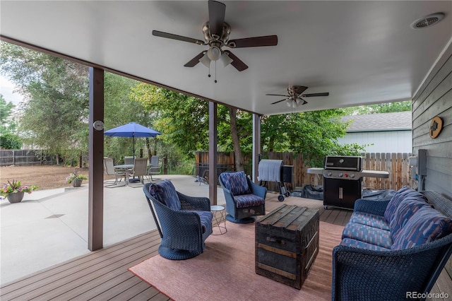10640 W 46th Ave, Wheat Ridge, CO 80033 - wooden terrace with grilling area, a fenced backyard, a ceiling fan, outdoor dining area, and an outdoor hangout area