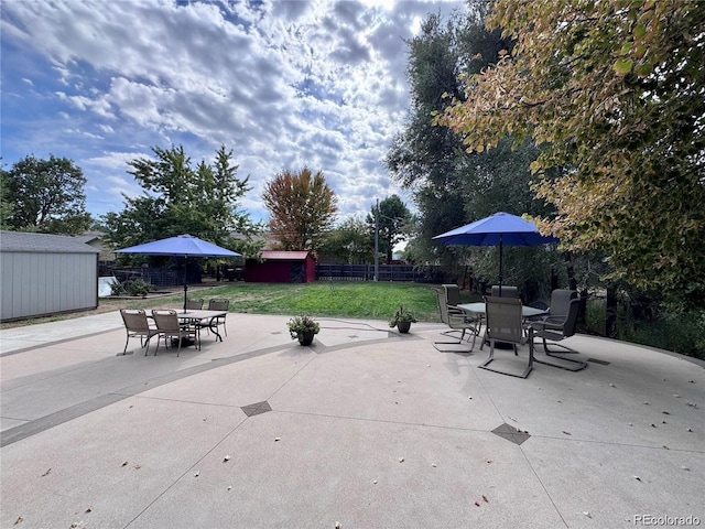 10640 W 46th Ave, Wheat Ridge, CO 80033 - view of patio featuring a storage unit, outdoor dining area, and an outdoor structure