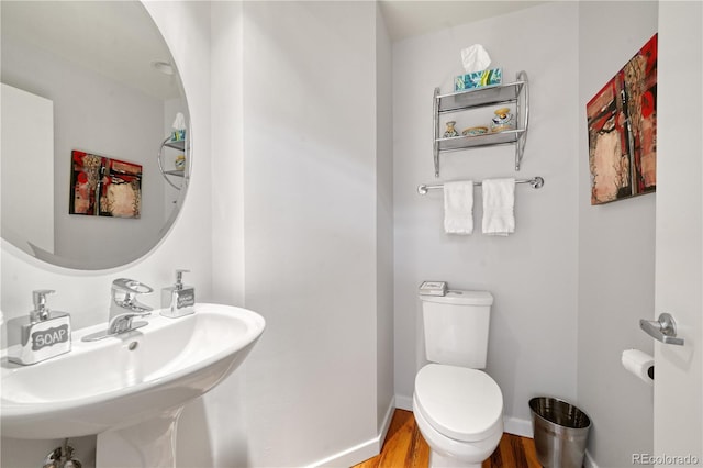 bathroom with sink, wood-type flooring, and toilet