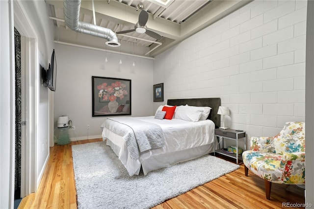 bedroom with hardwood / wood-style flooring and ceiling fan