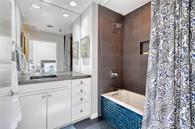 bathroom with vanity, shower / bathtub combination with curtain, and tile patterned flooring