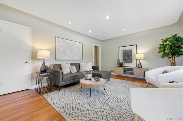 living area with wood finished floors, recessed lighting, and baseboards