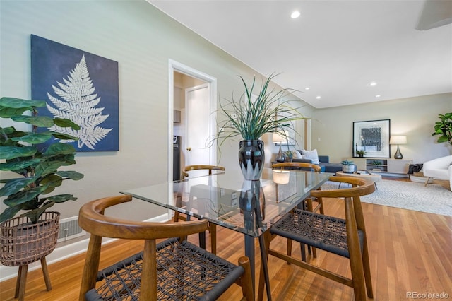 dining area featuring light wood finished floors, recessed lighting, and baseboards