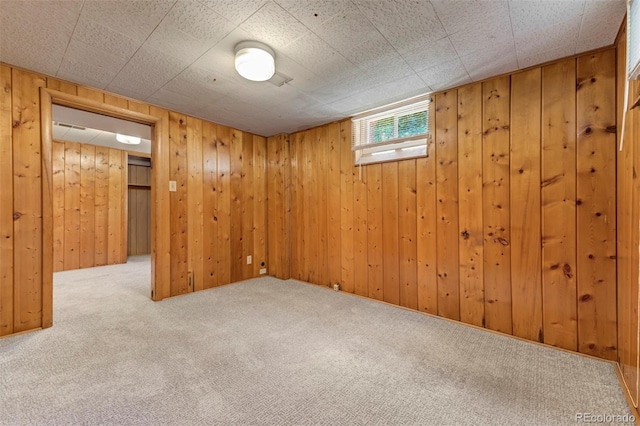 basement with carpet flooring and wooden walls