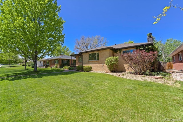 view of front of property with a chimney and brick siding