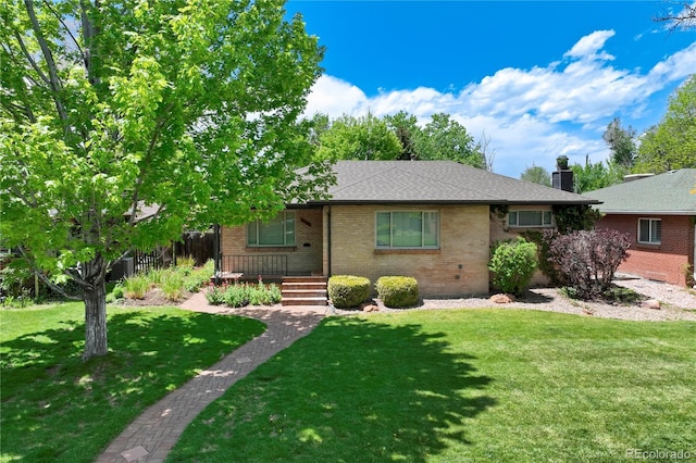 3245 S High St, Englewood, CO 80113 - view of front of property featuring brick siding, a front yard, and a chimney