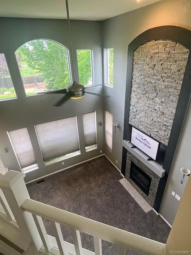 12742 Clermont St, Thornton, CO 80241 - entryway with carpet flooring, a ceiling fan, and a fireplace