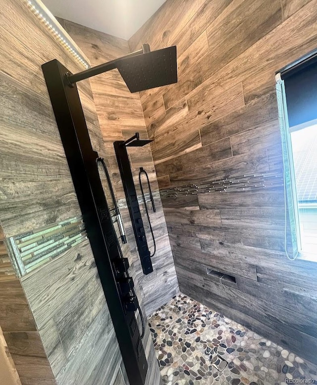 12742 Clermont St, Thornton, CO 80241 - full bathroom featuring wooden walls, a shower stall, and stone floors
