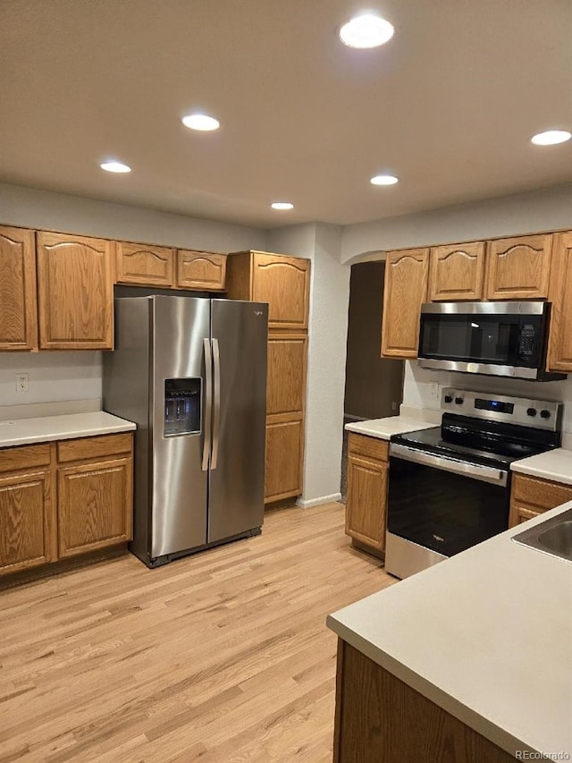 12742 Clermont St, Thornton, CO 80241 - kitchen featuring appliances with stainless steel finishes, light wood-style flooring, recessed lighting, and light countertops