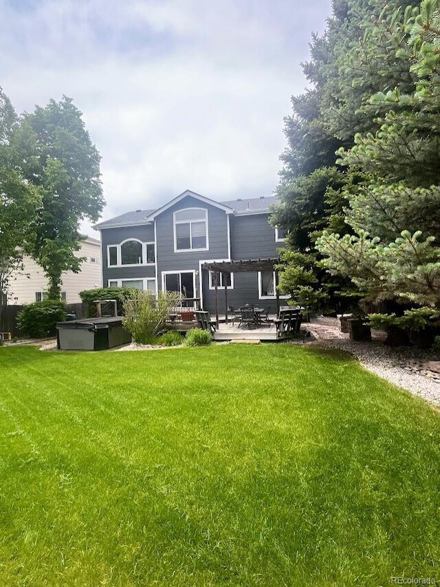 12742 Clermont St, Thornton, CO 80241 - back of property with a hot tub, a pergola, a yard, and a patio