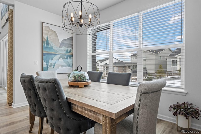 dining area with an inviting chandelier and hardwood / wood-style floors