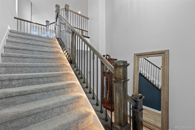 stairs featuring a high ceiling