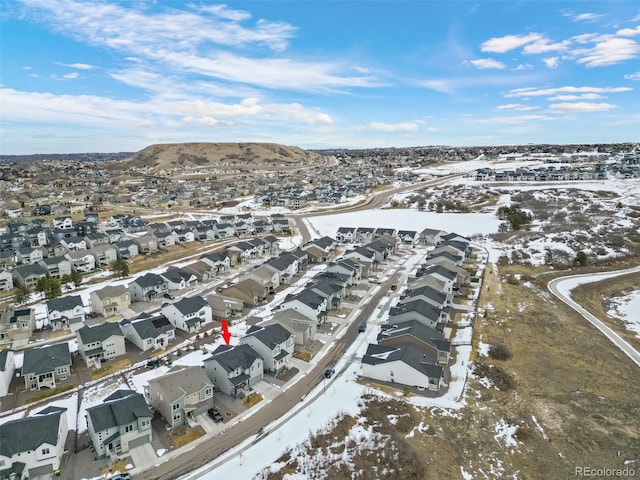 snowy aerial view featuring a mountain view