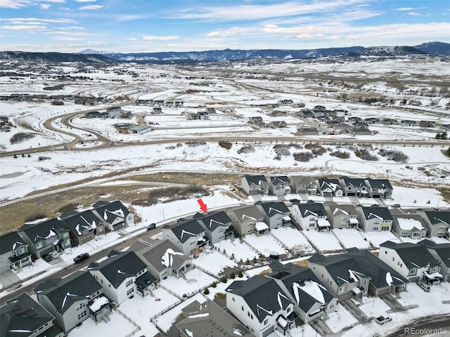 snowy aerial view featuring a mountain view