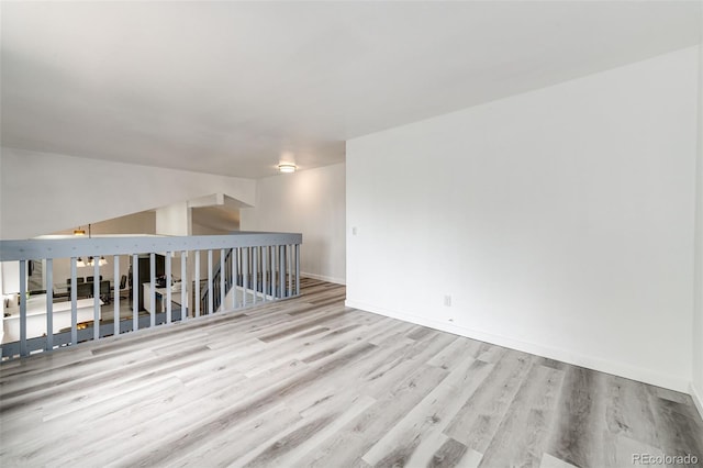 empty room featuring wood finished floors and baseboards