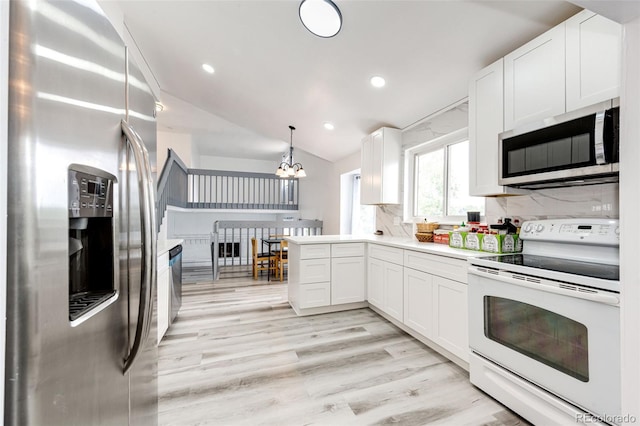 kitchen with light wood-style flooring, tasteful backsplash, stainless steel appliances, white cabinets, and light countertops