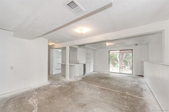 interior space with visible vents and a textured ceiling