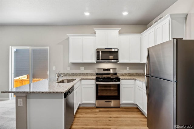 7326 Green River Ave, Frederick, CO 80530 - kitchen featuring stainless steel appliances, a sink, a peninsula, white cabinets, and recessed lighting