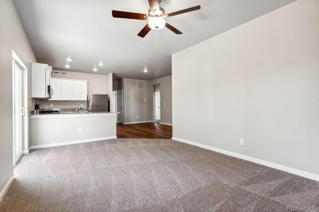 7326 Green River Ave, Frederick, CO 80530 - unfurnished living room featuring carpet flooring, baseboards, ceiling fan, a sink, and recessed lighting