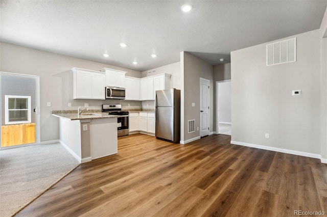 7326 Green River Ave, Frederick, CO 80530 - kitchen featuring stainless steel appliances, baseboards, white cabinetry, recessed lighting, and light stone counters