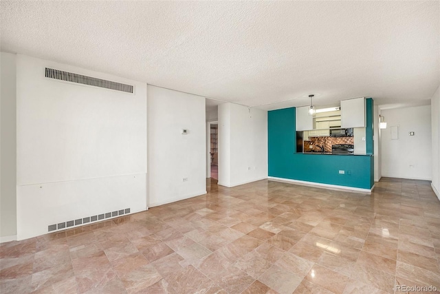 unfurnished living room featuring a textured ceiling