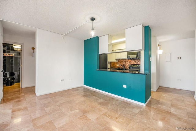 interior space featuring sink and a textured ceiling