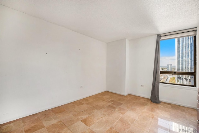 empty room featuring a textured ceiling