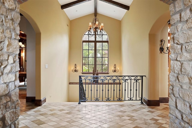 interior space with beamed ceiling, a chandelier, and high vaulted ceiling