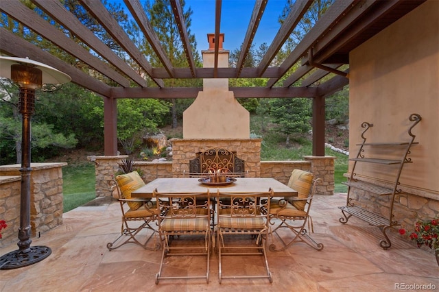 view of patio / terrace with a pergola and an outdoor stone fireplace