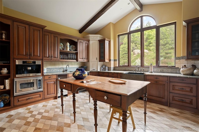 kitchen featuring tasteful backsplash, lofted ceiling with beams, sink, and stainless steel appliances