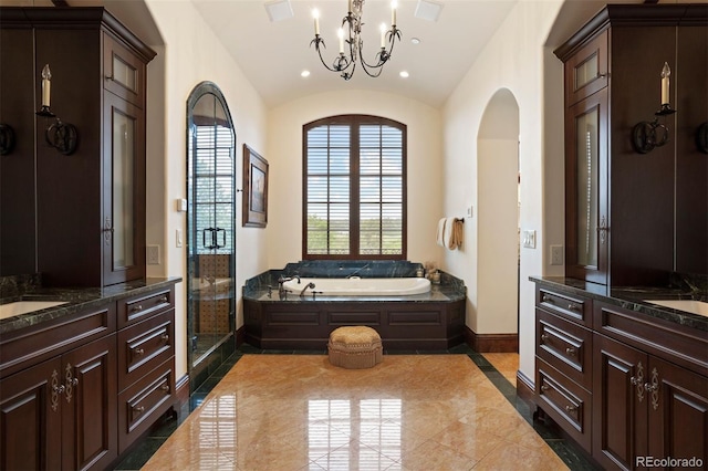 bathroom with vanity, lofted ceiling, shower with separate bathtub, and an inviting chandelier