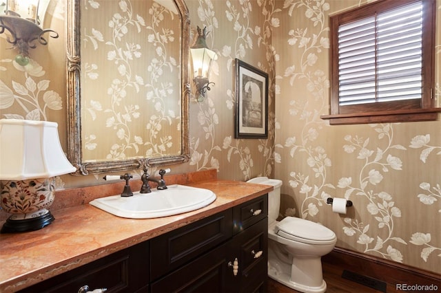 bathroom featuring vanity and toilet